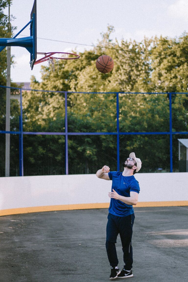 a man in a blue shirt playing basketball