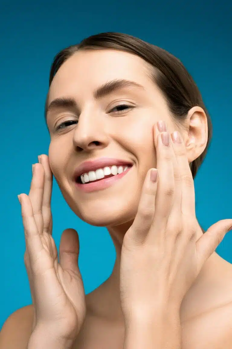 smiling woman with both hands on her face
