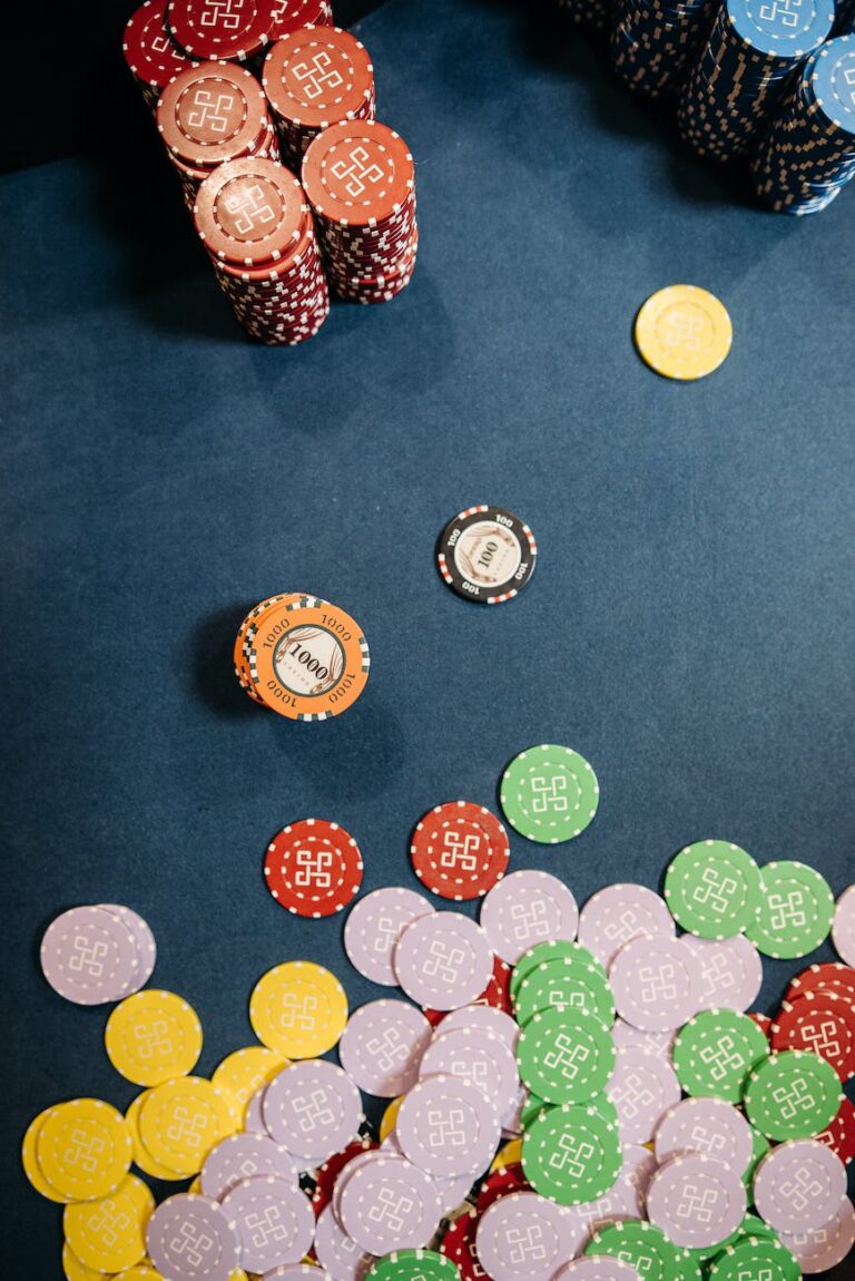 assorted gambling chips on a blue table