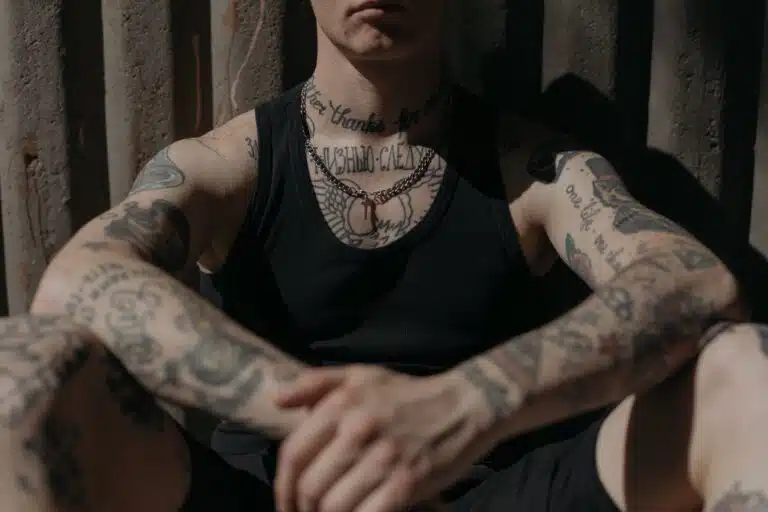 a tattooed man wearing black tank top